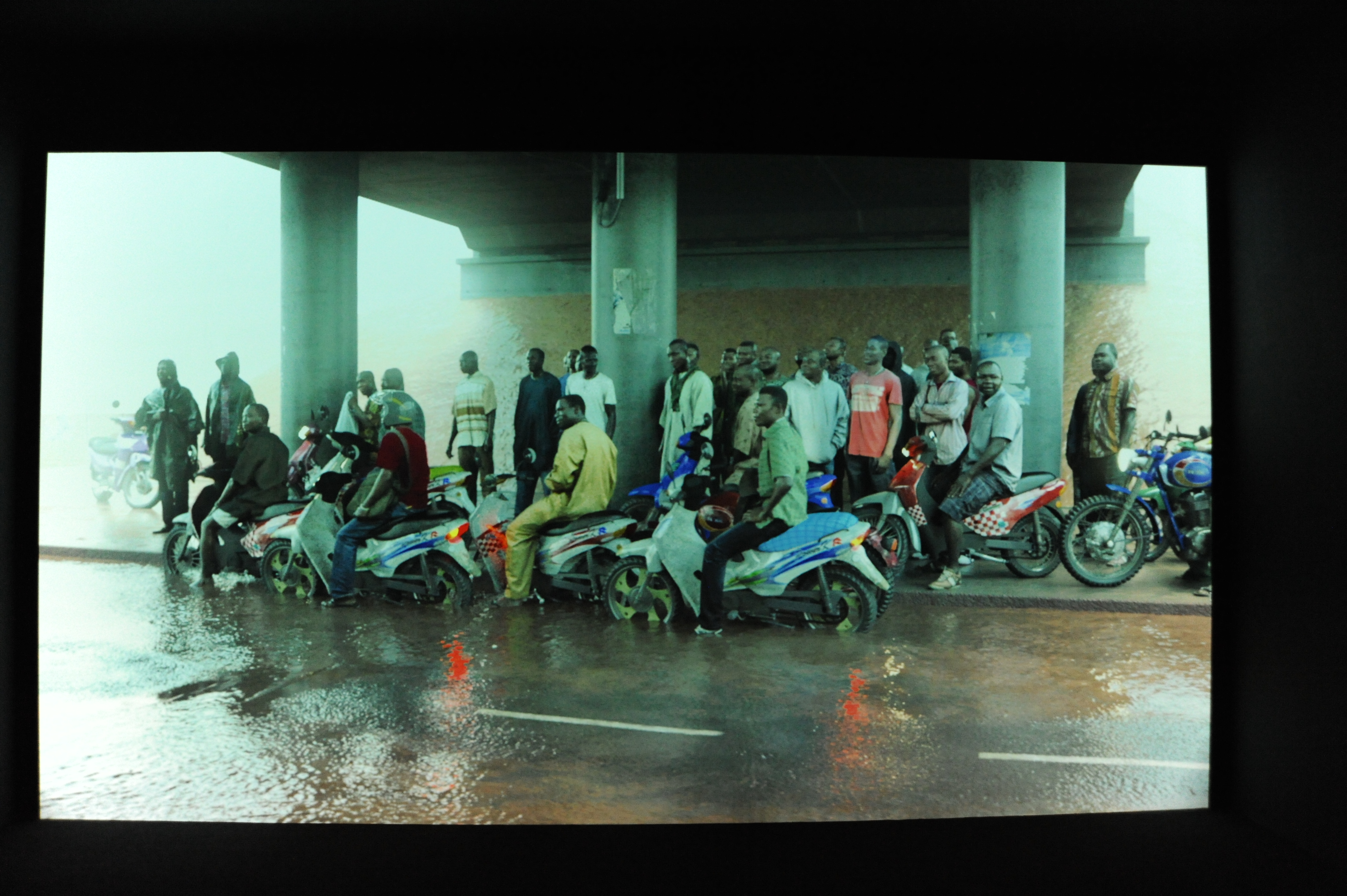 Oil workers (from the Shell company of Nigeria) returning home from work, caught in torrential rain Image